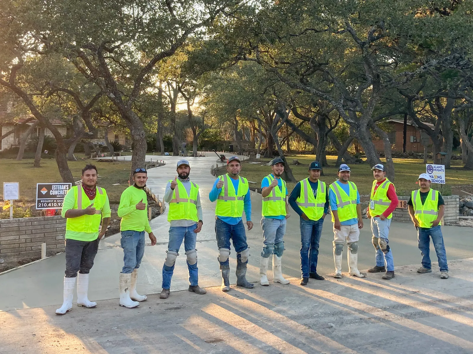 The crew standing on a finished residential driveway