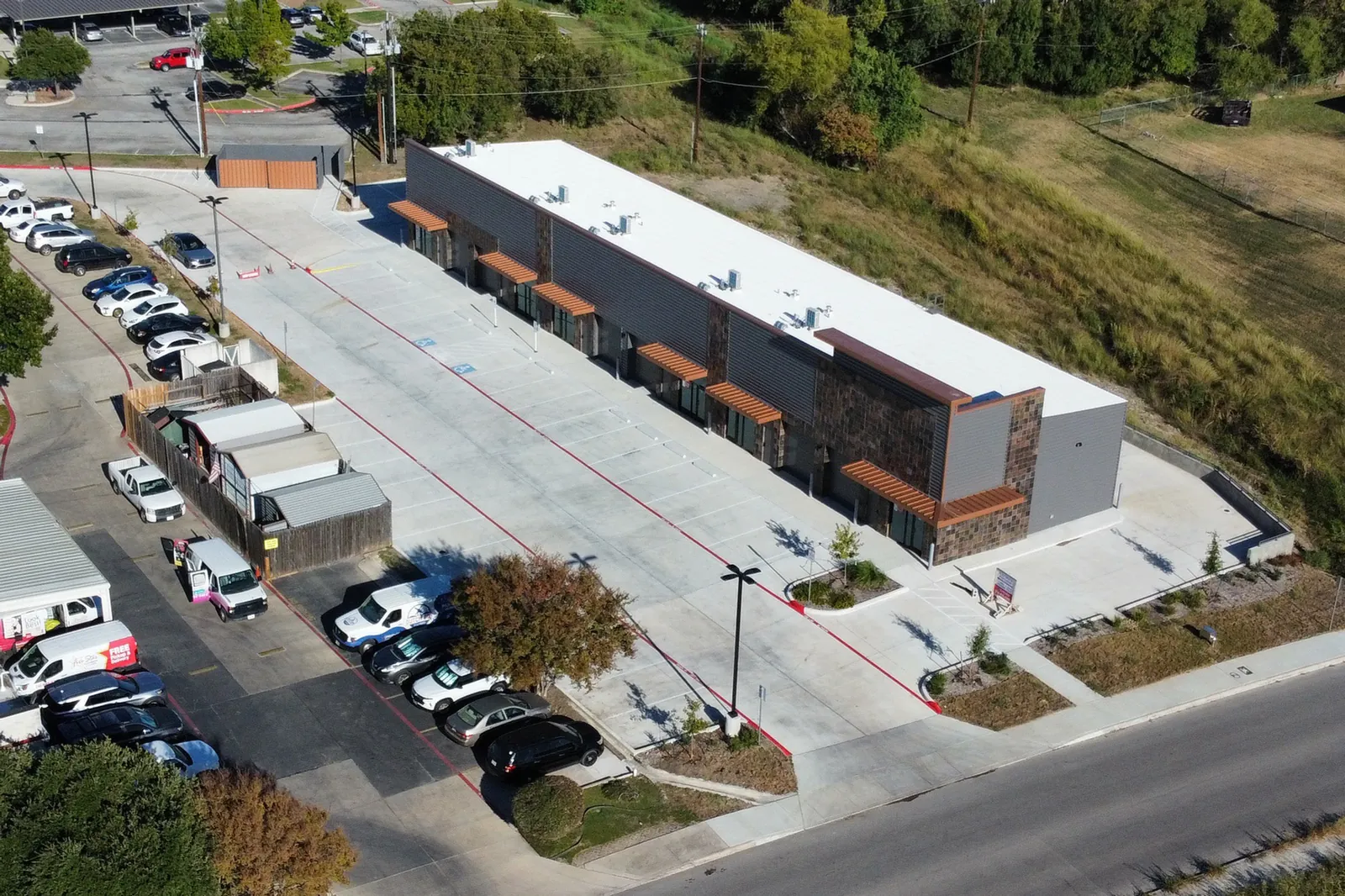 Aerial view of retail center concrete paving and parking lot