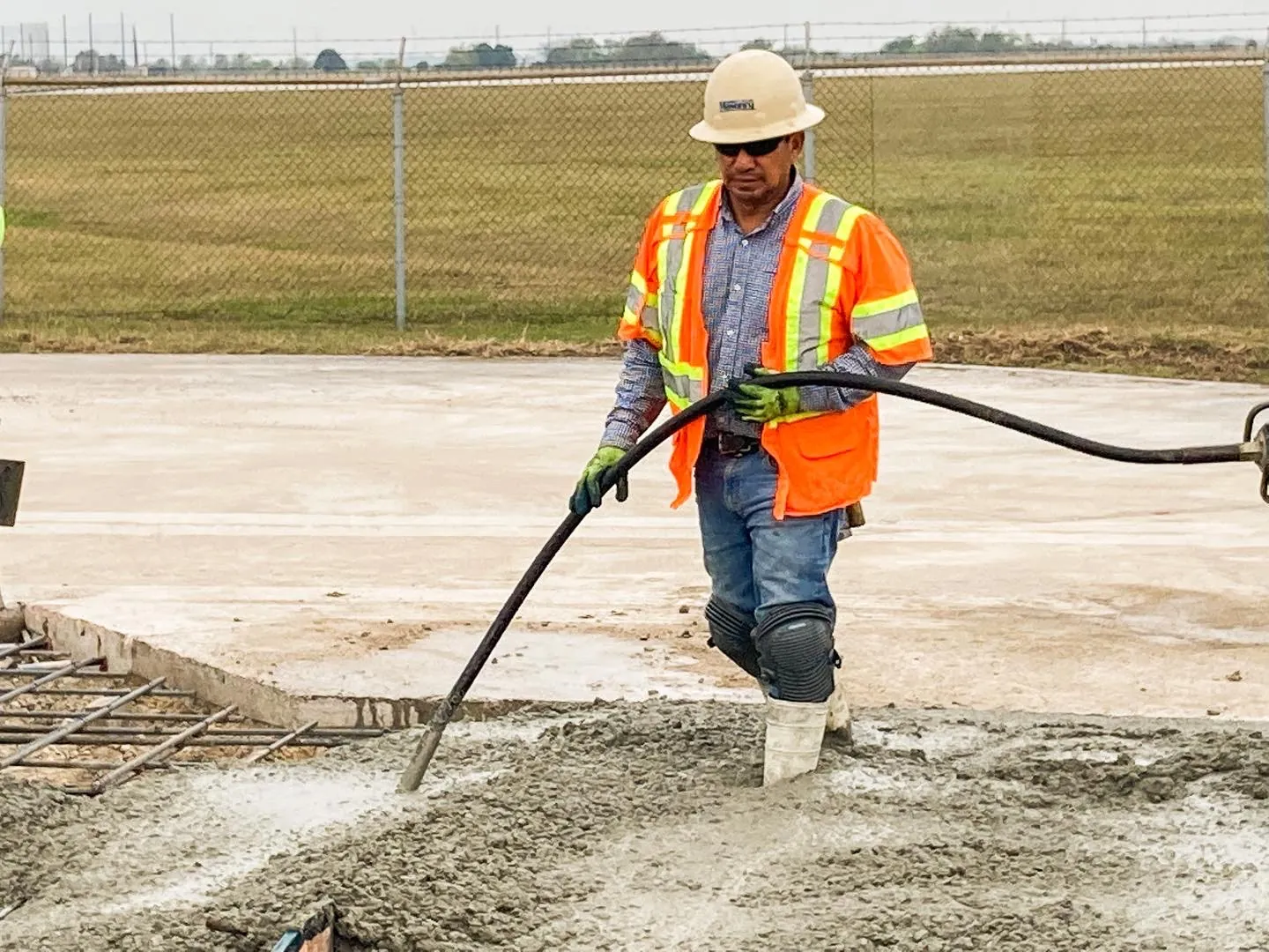 Concrete finisher screeding a fresh slab